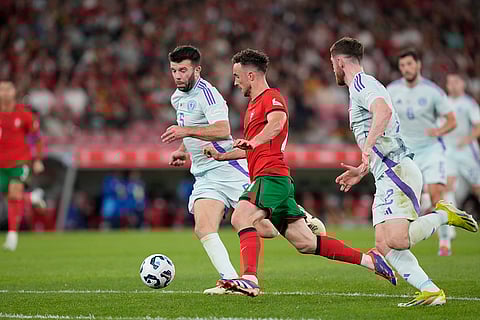 2024–25 UEFA Nations League, Portugal vs Scotland: Portugal's Diogo Jota, centre, challenges for the ball with Scotland's Grant Hanley, left, and Anthony Ralston